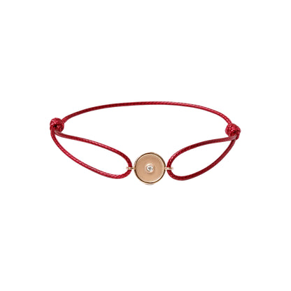 Red bracelet with a gold clasp on a white background