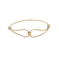 Gold bracelet with a unique design on a white background