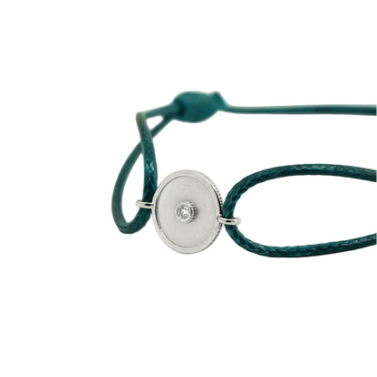 Green bracelet with a white gold clasp on a white background