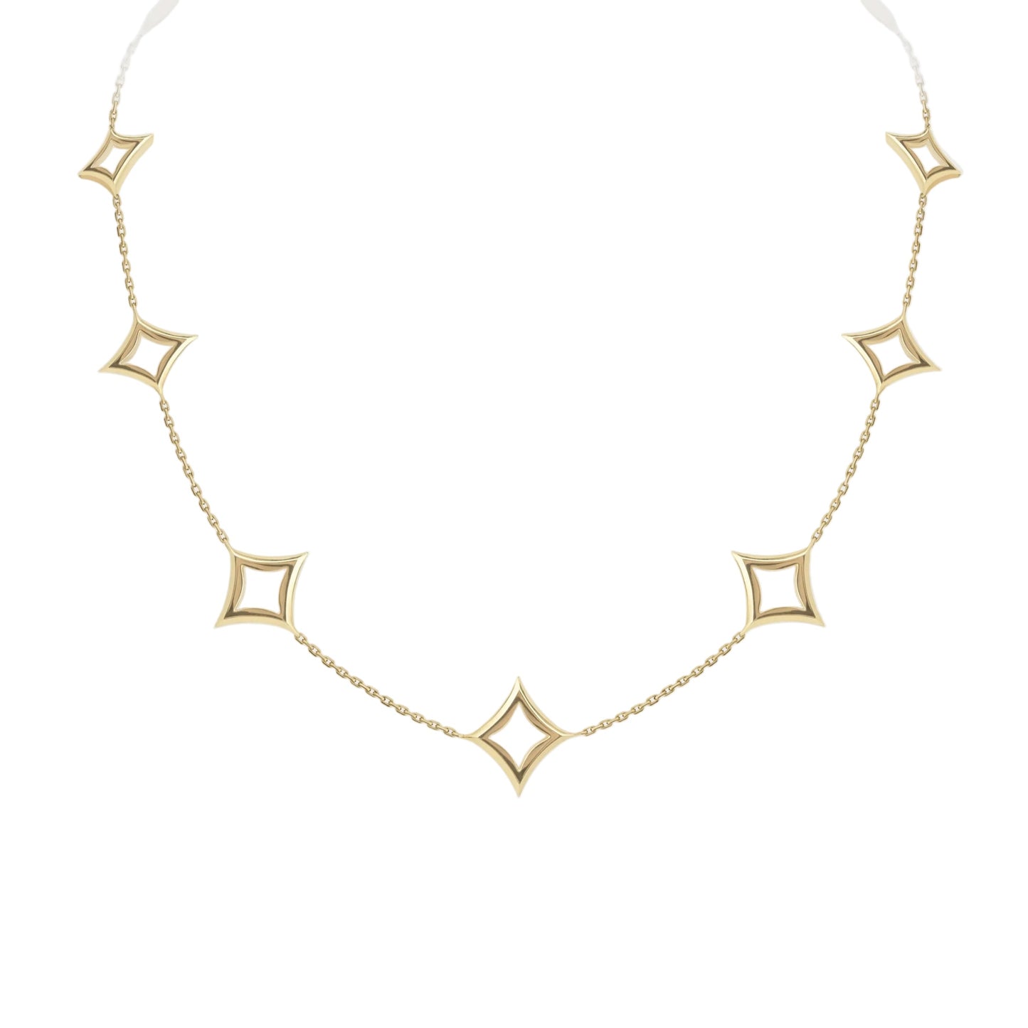 Gold necklace with star-shaped pendants on a light gray background