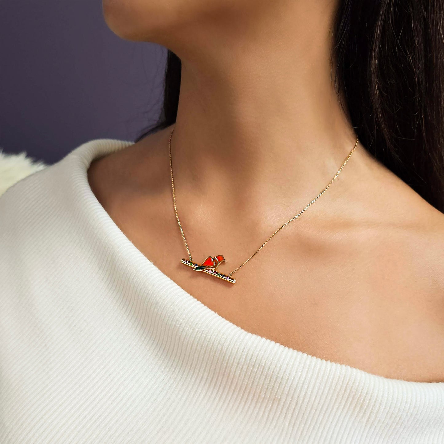 Necklace with a heart pendant worn by a person against a neutral background