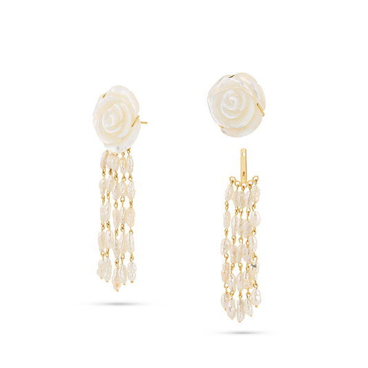 Pair of earrings with rose-shaped tops and pearl chains on a white background