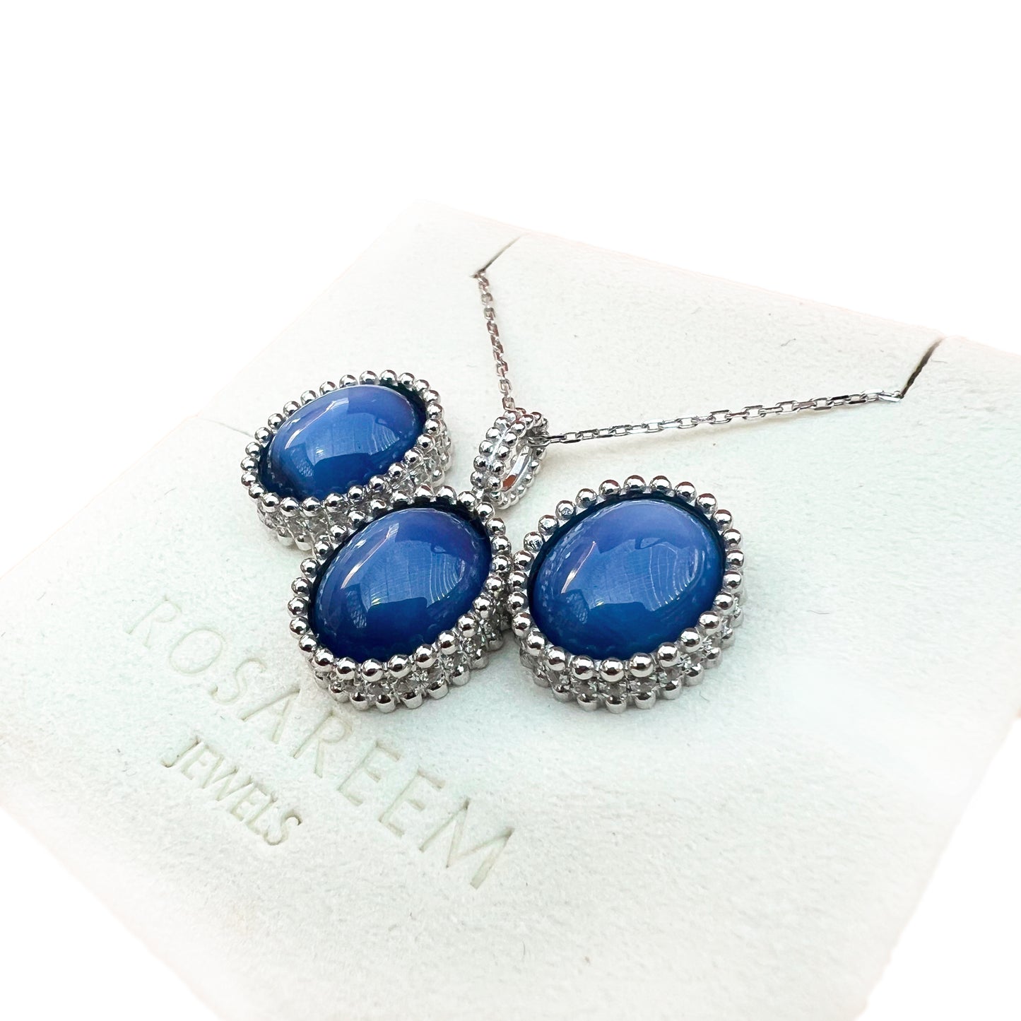 White gold necklace with blue stones on a white background