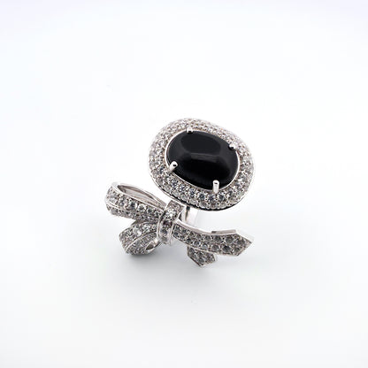 White gold ring with a black gemstone on a white background