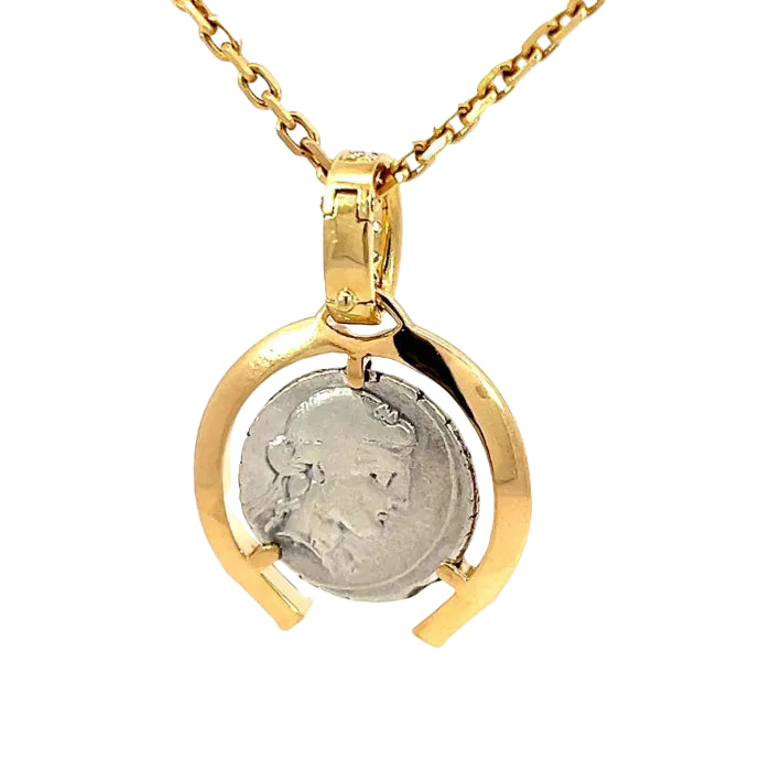 Gold necklace with a pendant featuring a silver coin on a white background