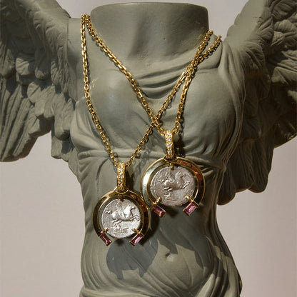 Gold necklaces with coin pendants on a classical statue