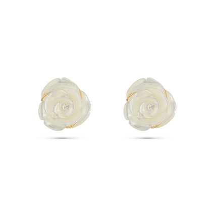Pair of white floral earrings with gold accents on a white background