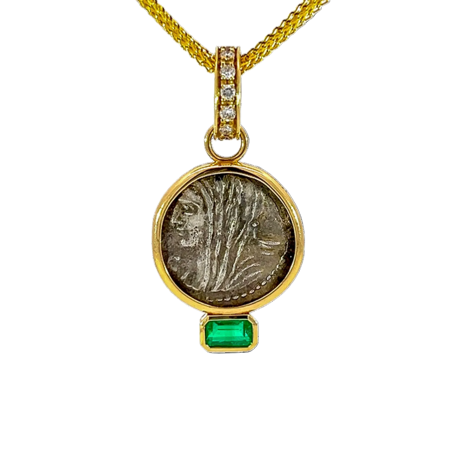 Gold pendant with a green gemstone on a white background