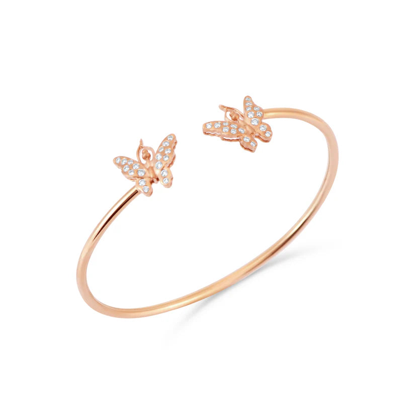 Rose gold bracelet with butterfly charms on a white background