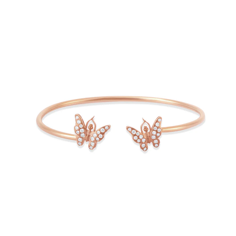 Rose gold bracelet with butterfly charms on a white background