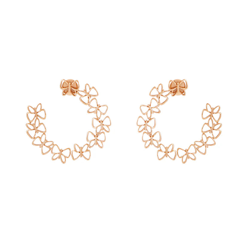 Rose gold floral hoop earrings on a white background