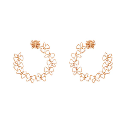 Rose gold floral hoop earrings on a white background