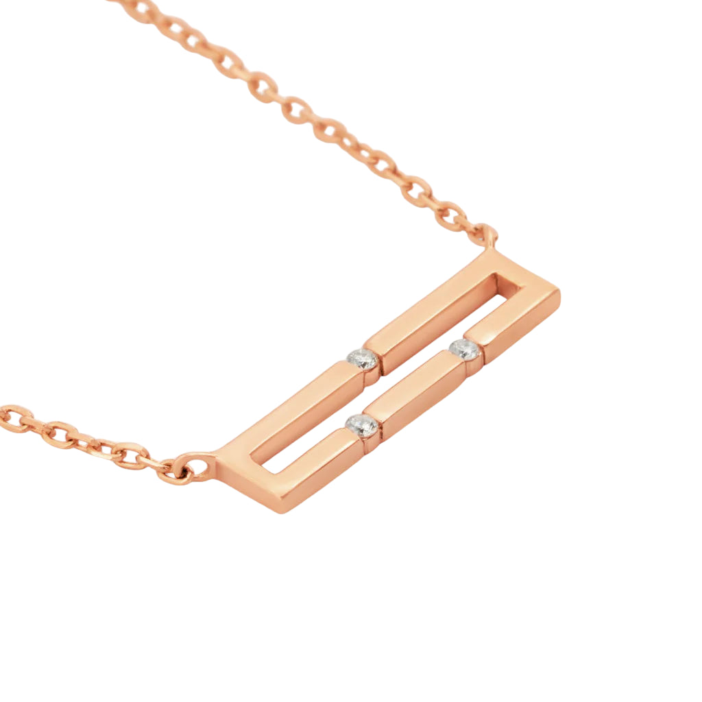 Rose gold necklace with a rectangular pendant on a white background