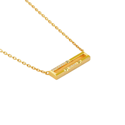 Gold necklace with a rectangular pendant on a white background