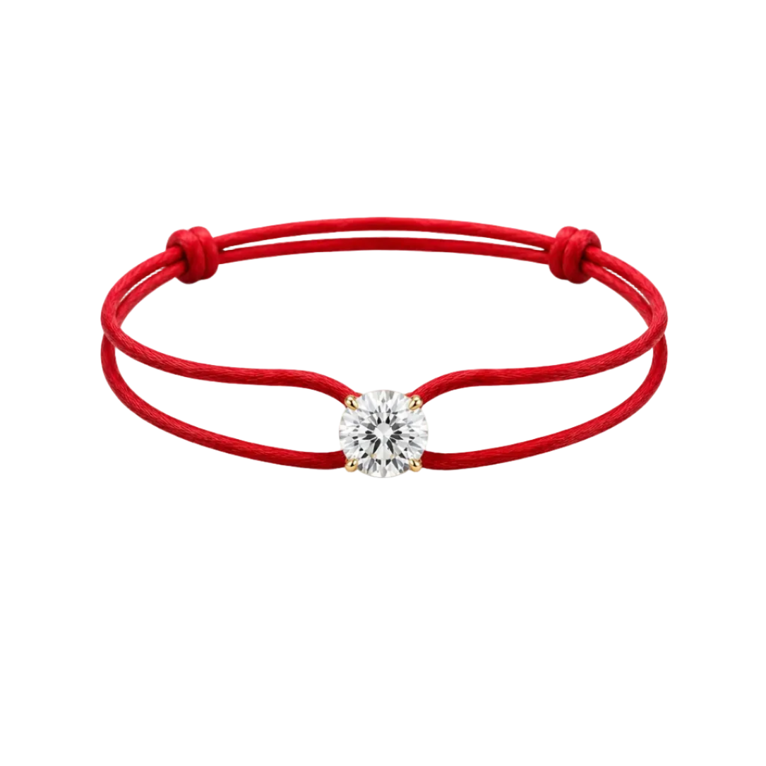 Red string bracelet with a diamond on a white background