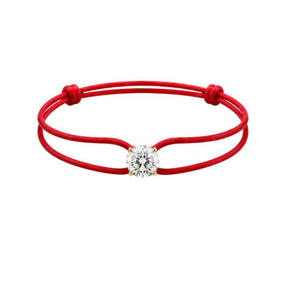 Red string bracelet with a diamond on a white background