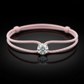 Pink bracelet with a diamond on a black background