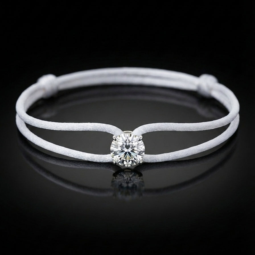 White leather bracelet with a central diamond on a black background