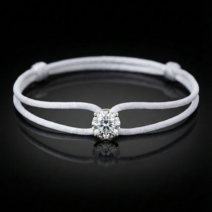 White leather bracelet with a central diamond on a black background