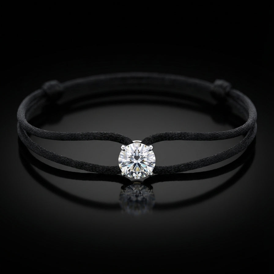 Black cord bracelet with a diamond on a black background