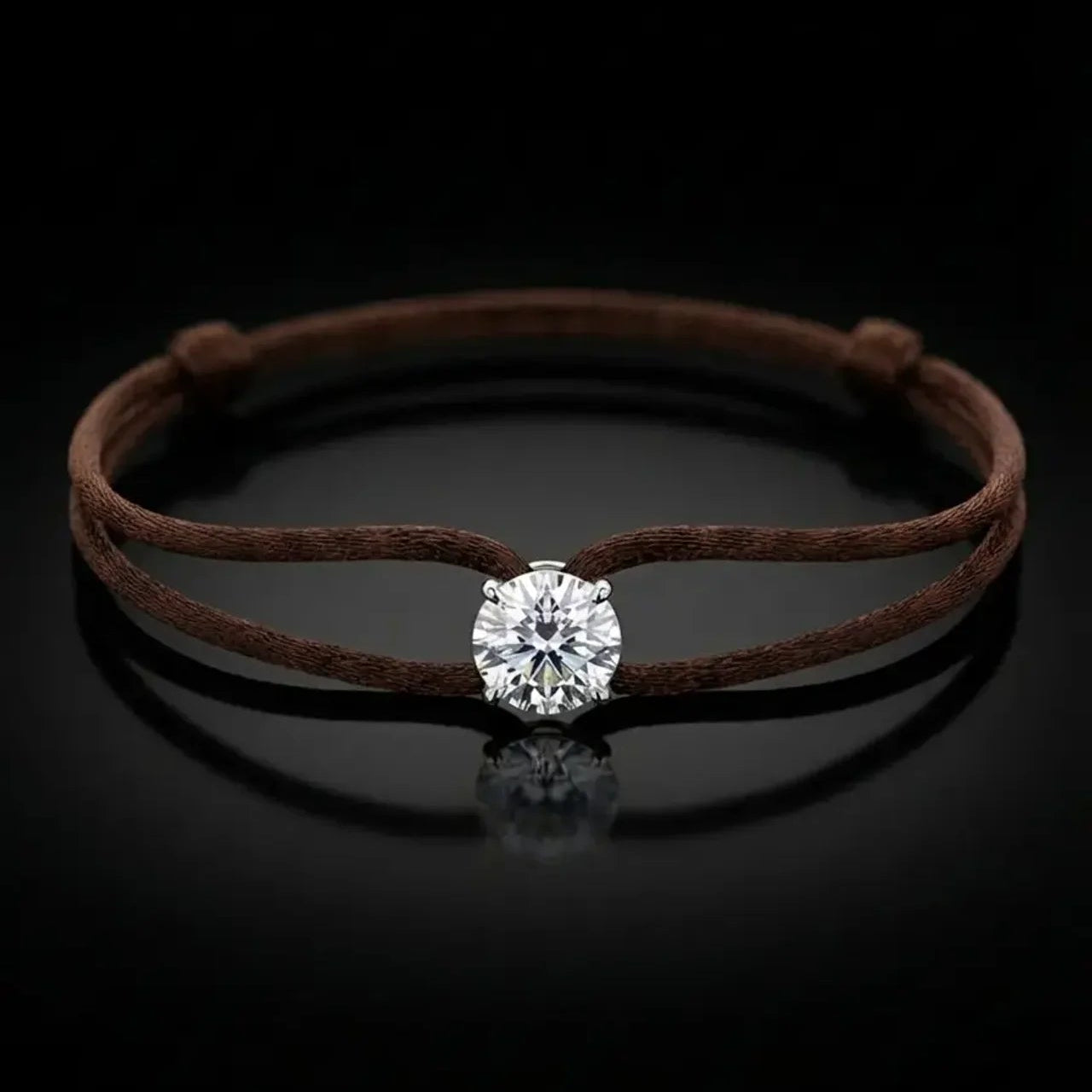 Brown cord bracelet with a diamond on a black background