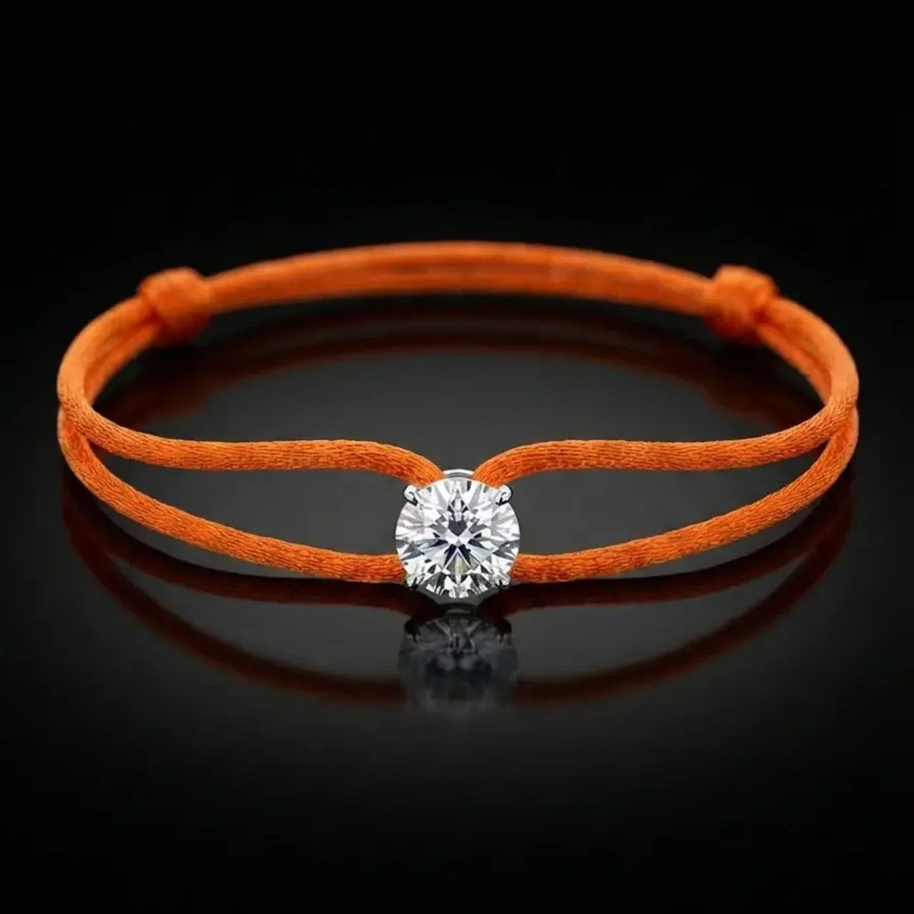 Orange bracelet with a diamond on a black background