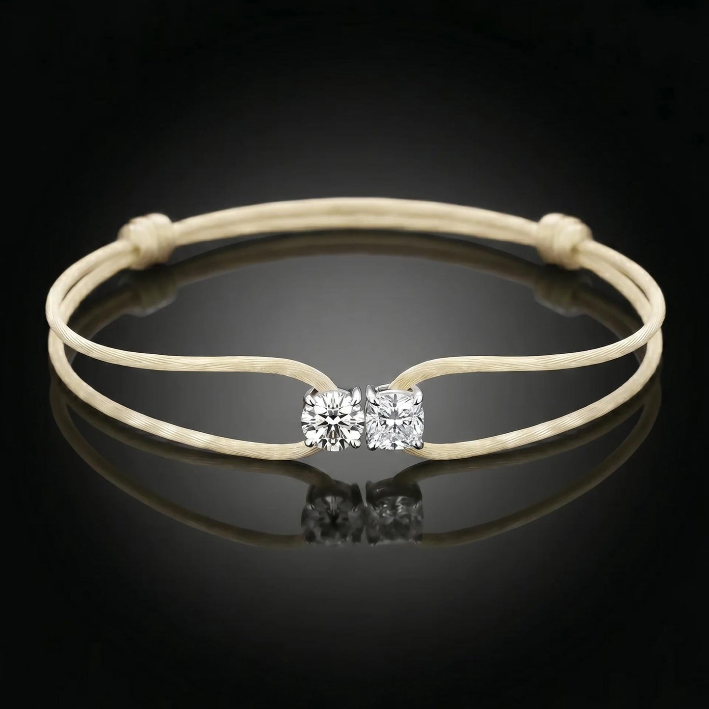 Beige bracelet with a diamond clasp on a black background