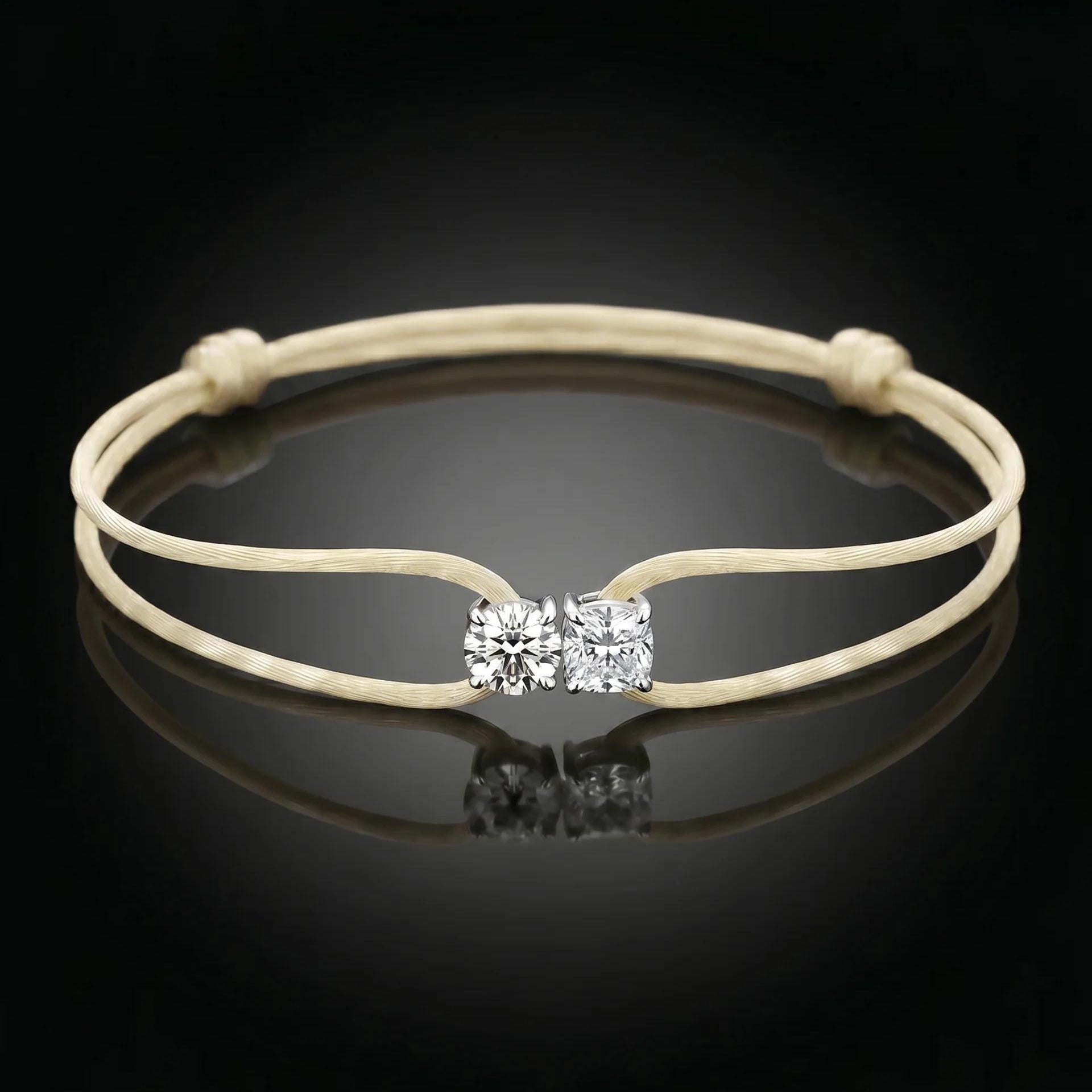 Beige bracelet with a diamond clasp on a black background