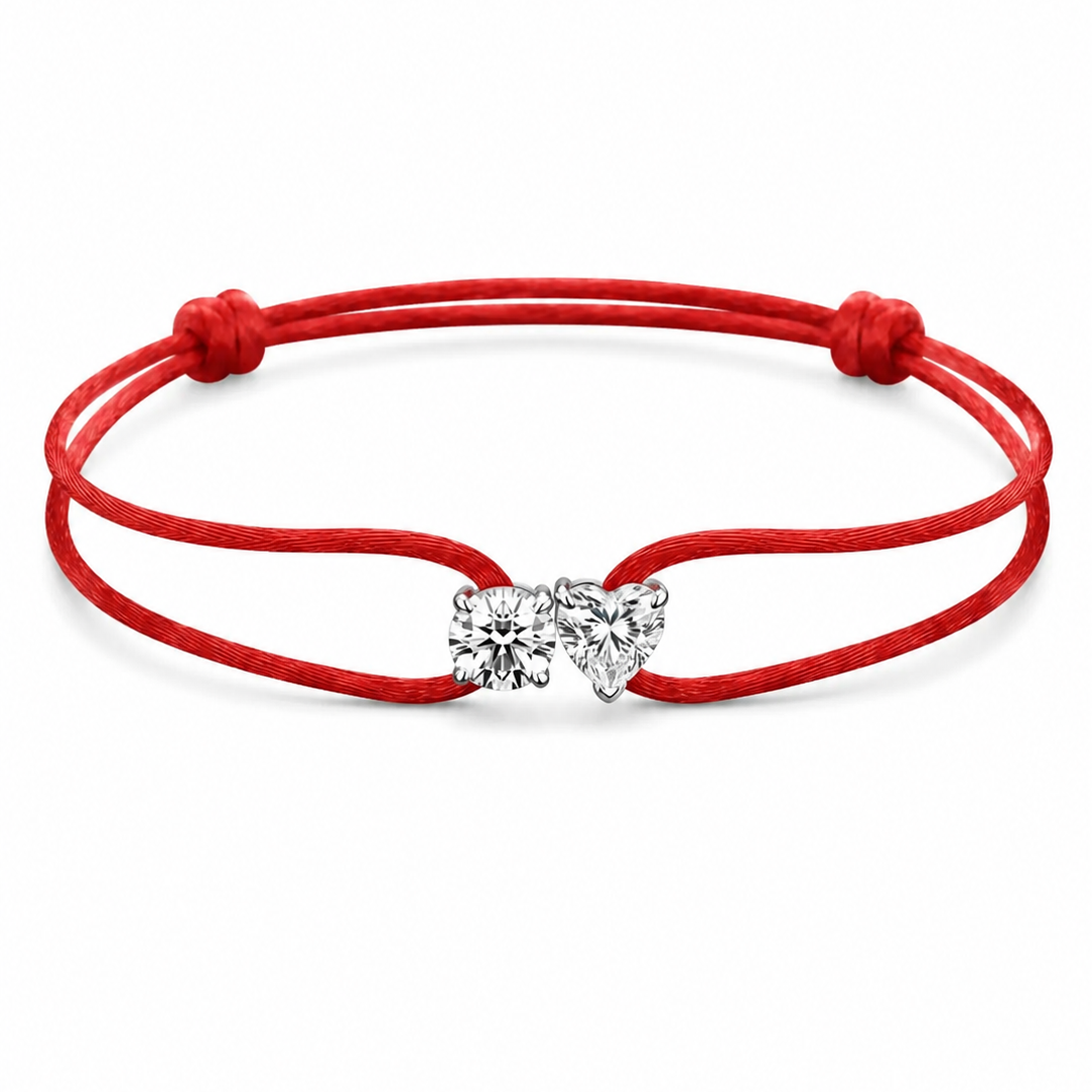 Red bracelet with a heart-shaped charm on a white background