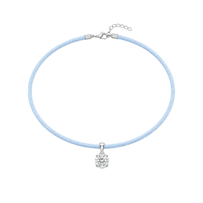 Necklace with a light blue cord and white gold clasp on a white background