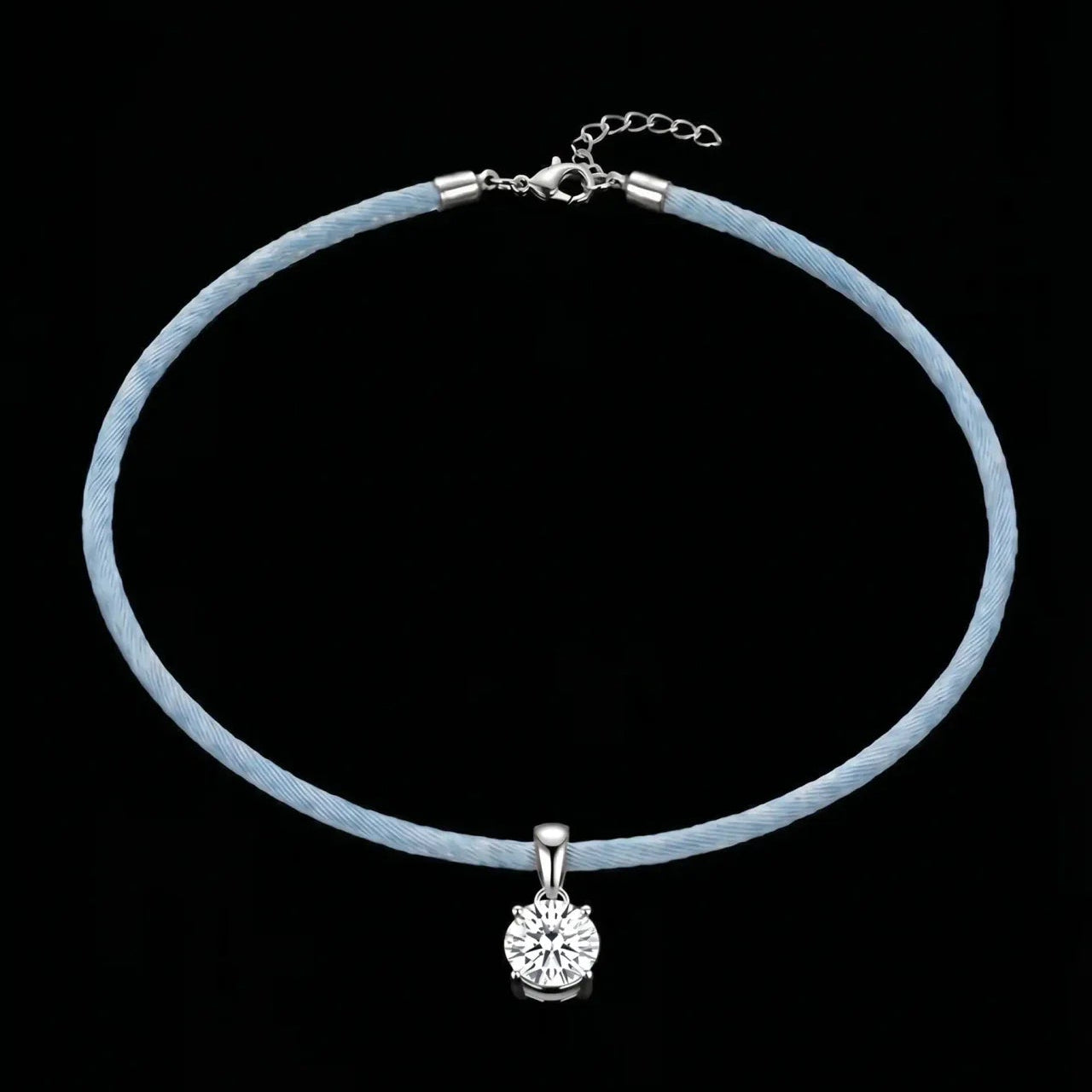Necklace with a blue cord and silver clasp on a black background