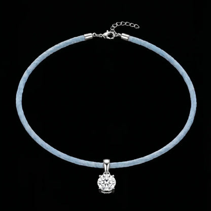 Necklace with a blue cord and silver clasp on a black background