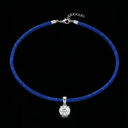 Blue choker necklace with a silver pendant on a black background