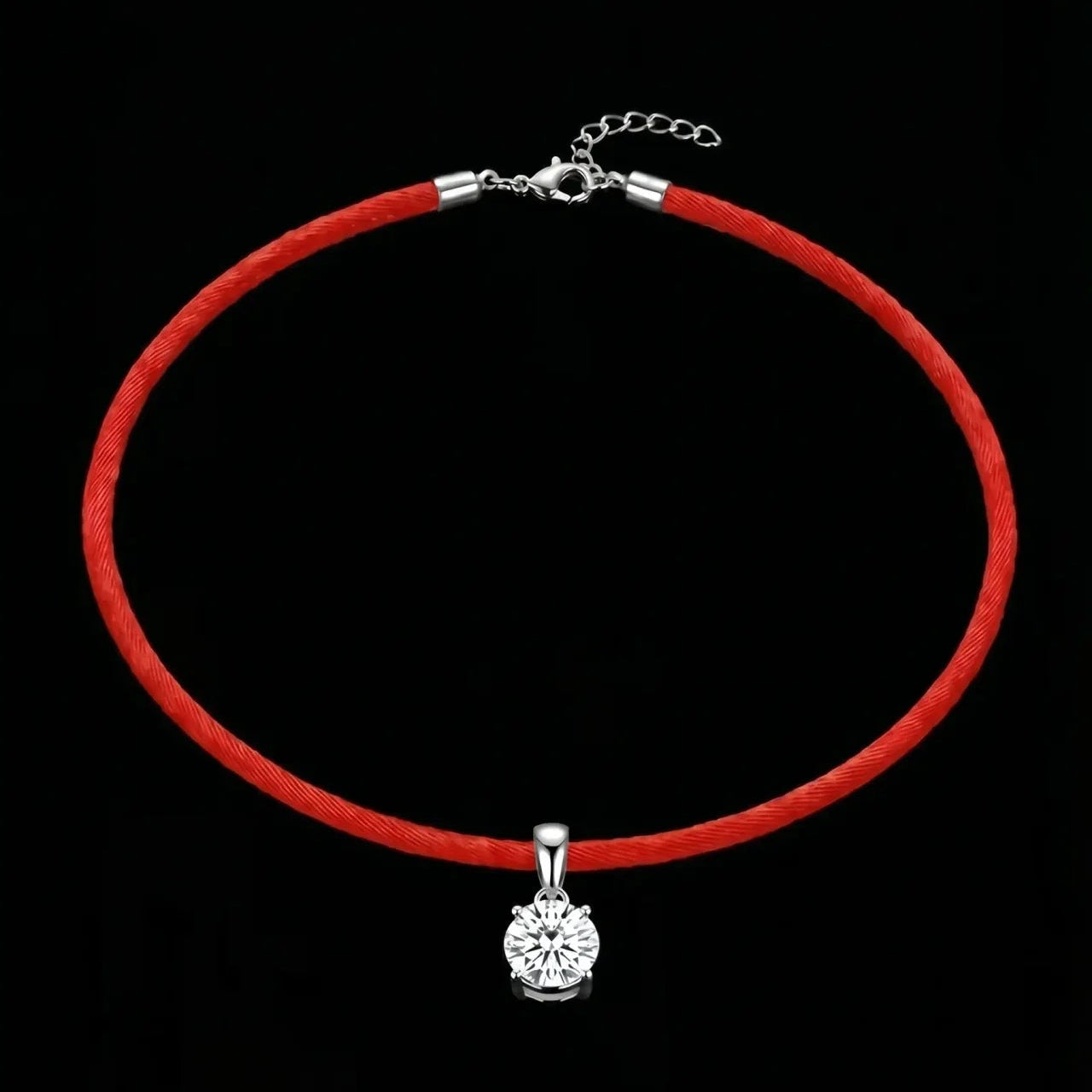 Red choker necklace with a silver pendant on a black background