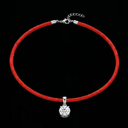 Red choker necklace with a silver pendant on a black background