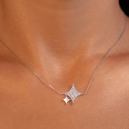 White gold star-shaped necklace on a person's neck