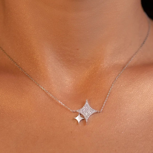 White gold star-shaped necklace on a person's neck