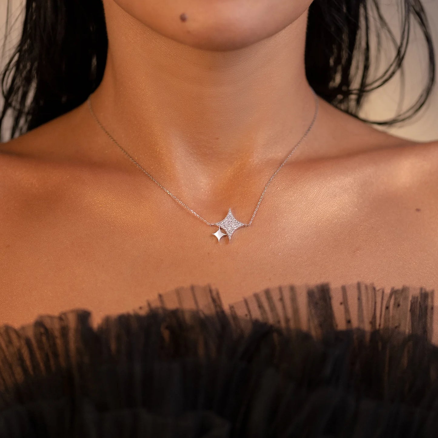 Necklace with a star-shaped pendant worn by a person
