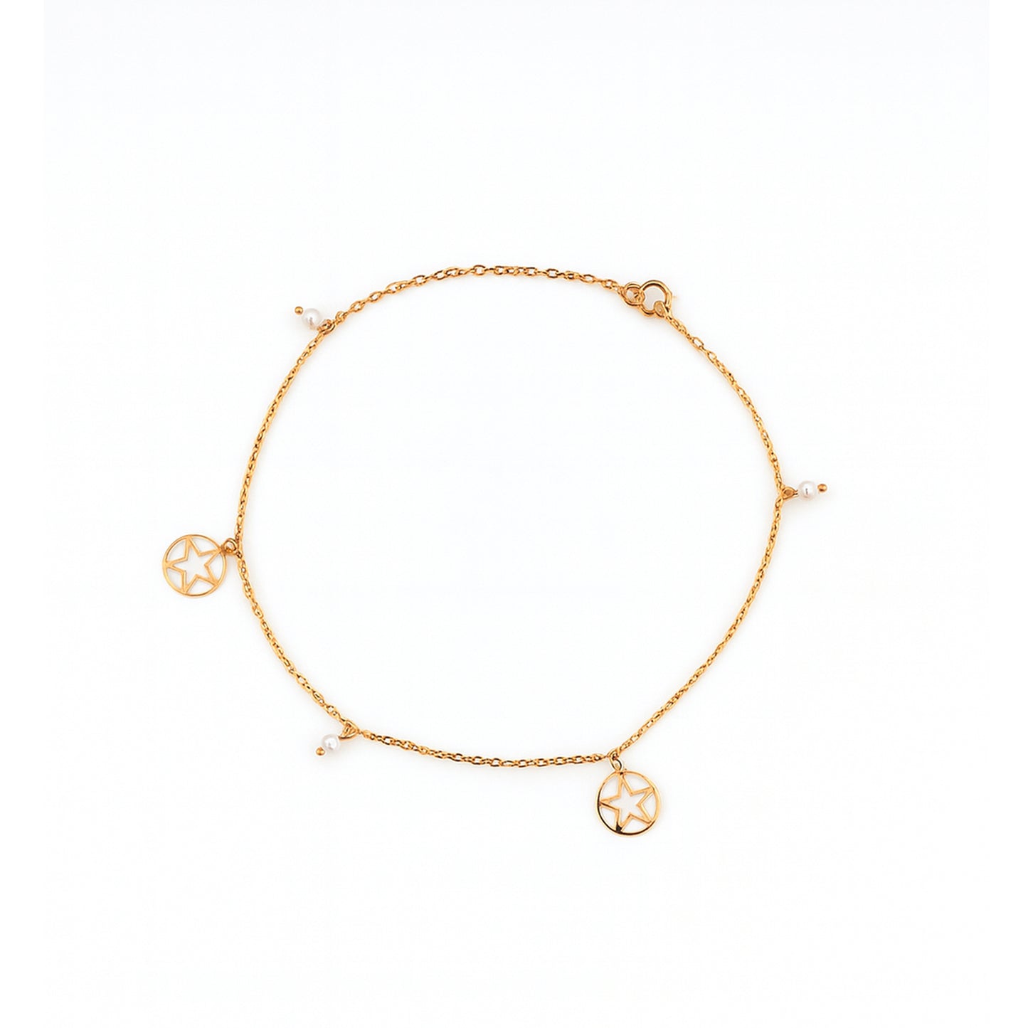 Gold anklet with circular charms on a white background