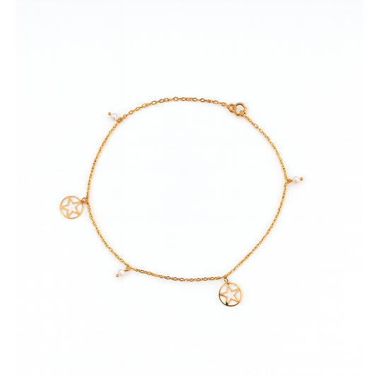 Gold anklet with circular charms on a white background