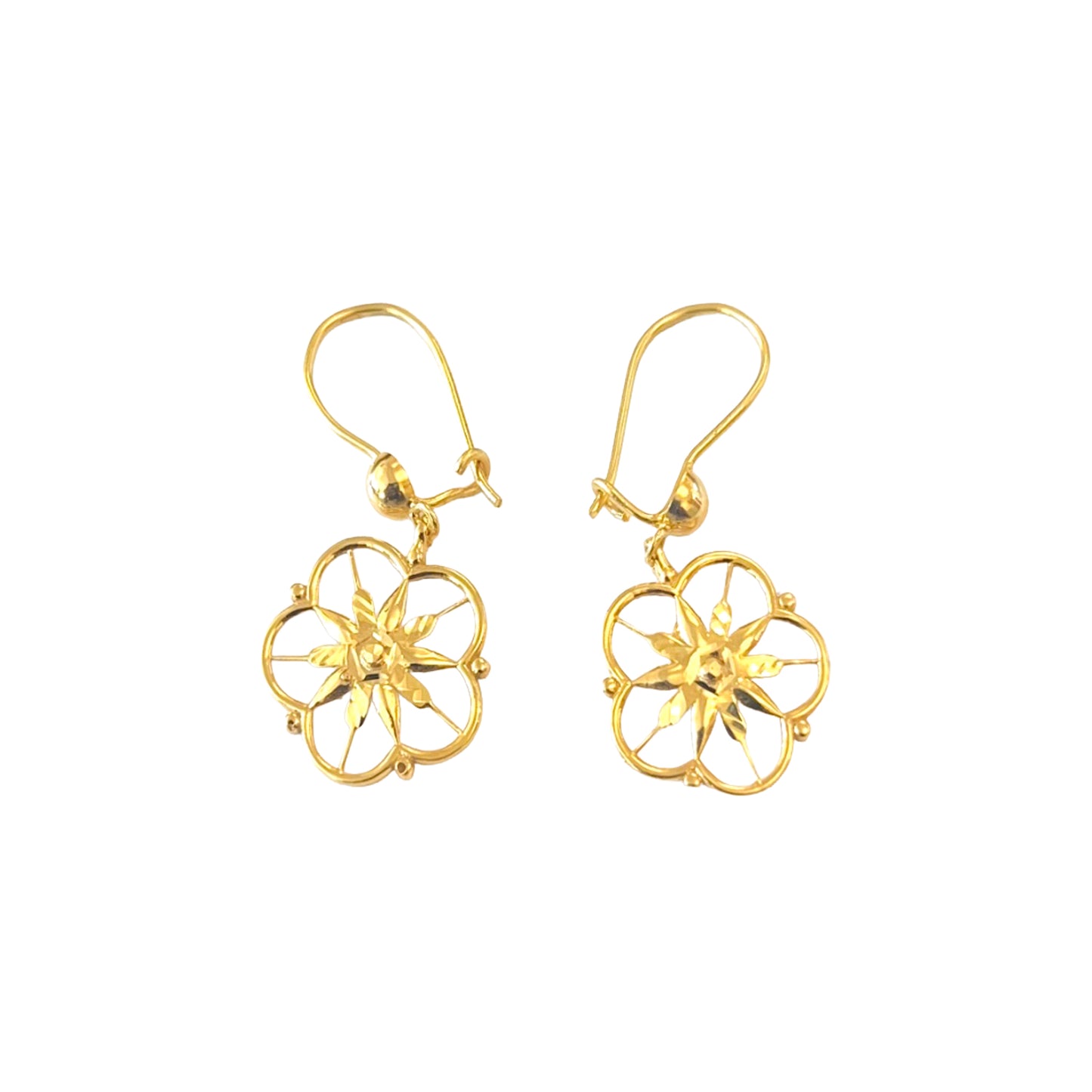 Gold floral earrings on a white background
