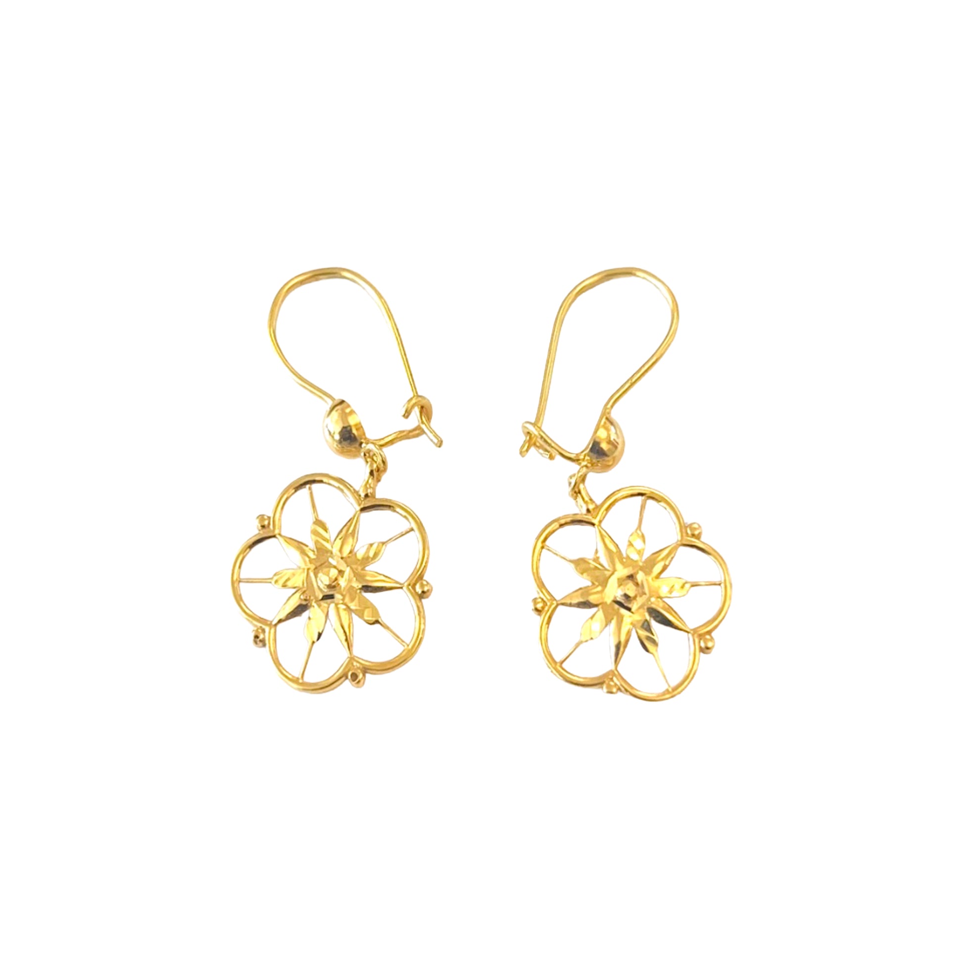 Gold floral earrings on a white background