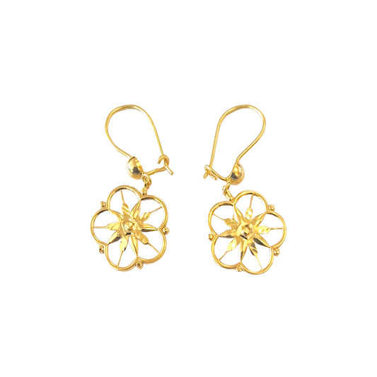 Gold floral earrings on a white background