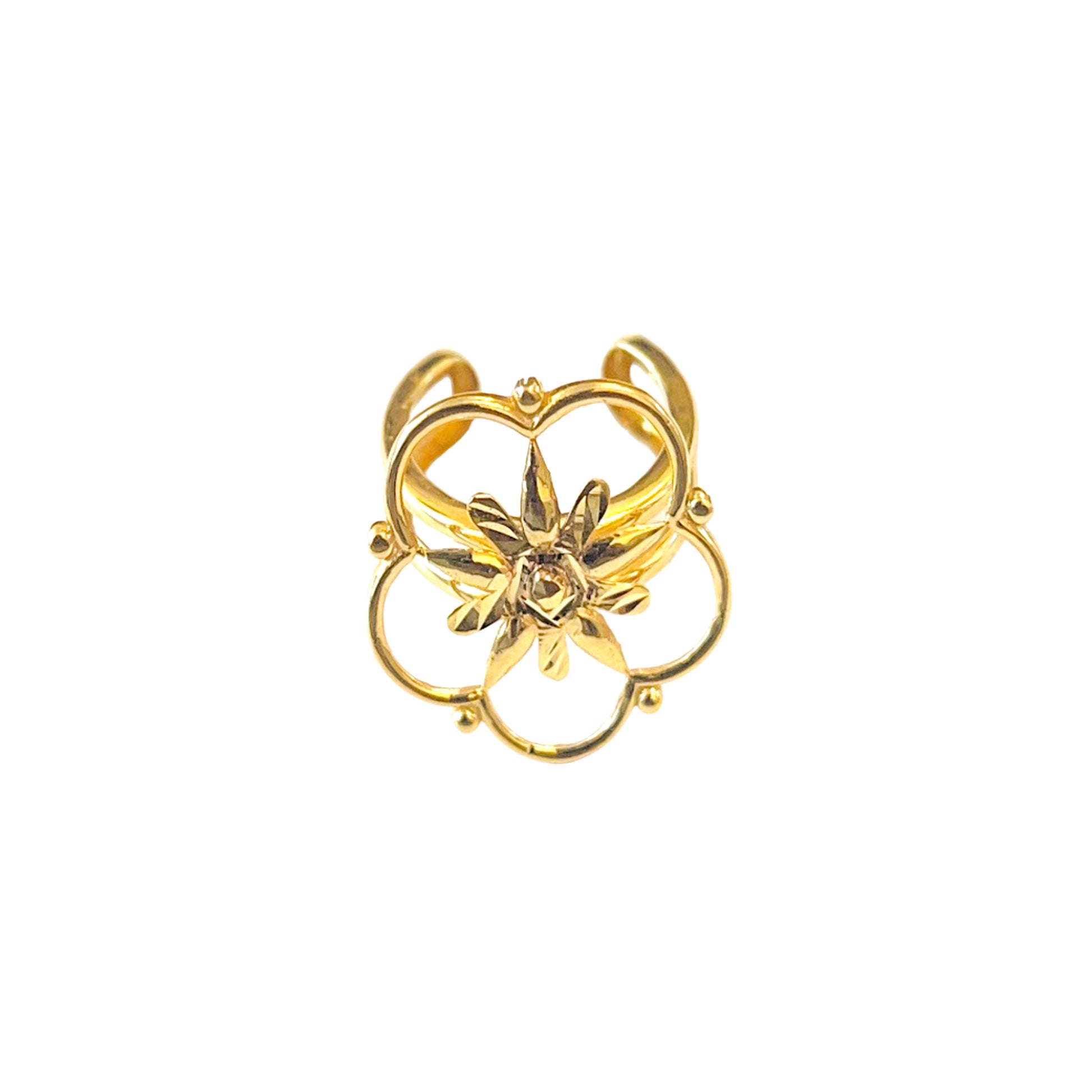 Gold ring with floral design on a white background