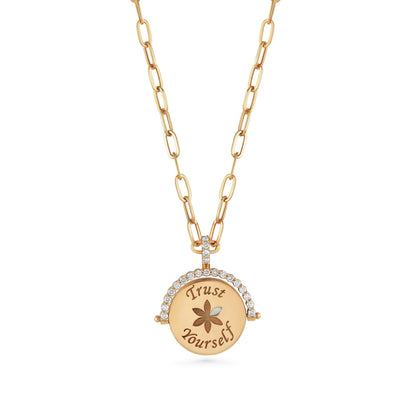 Gold necklace with a pendant that says 'Trust Yourself' on a white background