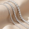 Two diamond bracelets on a soft beige background