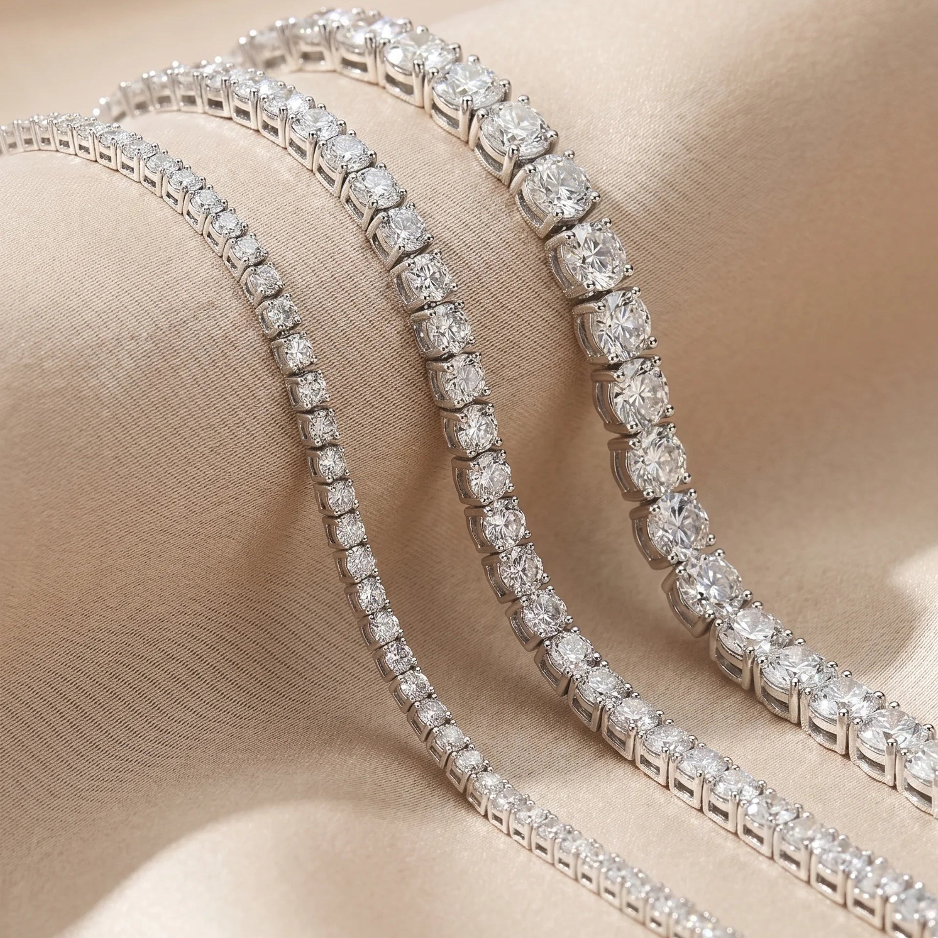 Two diamond bracelets on a soft beige background