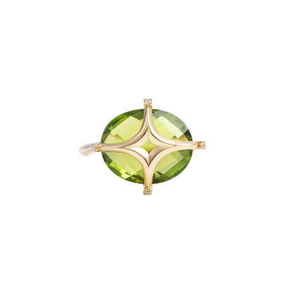 A gold ring featuring a large, round, faceted green gemstone in a four-prong setting, shown against a light gray background.
