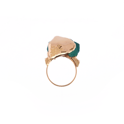 Gold earring with a green gemstone on a white background