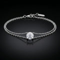 white gold bracelet with a single diamond on a black background
